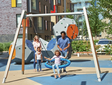 Family enjoying the play area at Greenwich Millennium Village